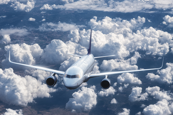 Passenger airplane flying above the clouds