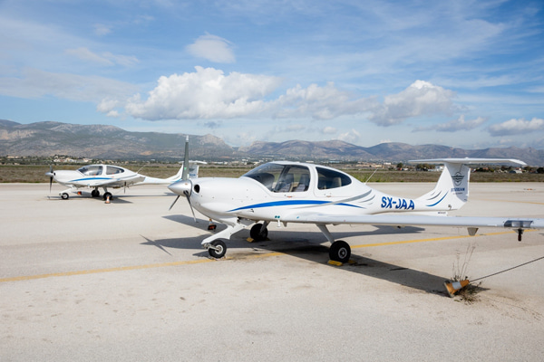 Two-seat aircraft parked at airport apron