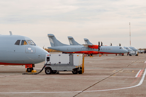 Turboprop aircraft parked next to support equipment