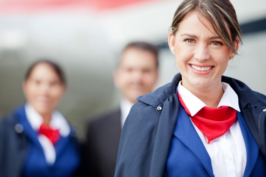 Flight attendant with airline crew in background