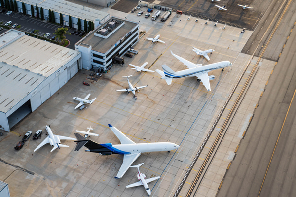 Aerial view of an airport with several parked aircrafts near buildings