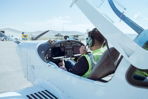 Student pilot sitting in the cockpit of a small training aircraft