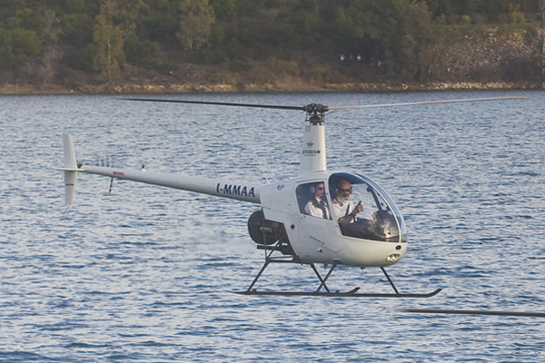 Helicopter hovering near a body of water