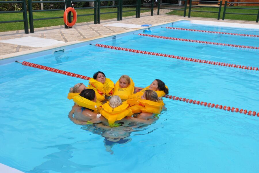 Cabin crew practicing water survival procedures