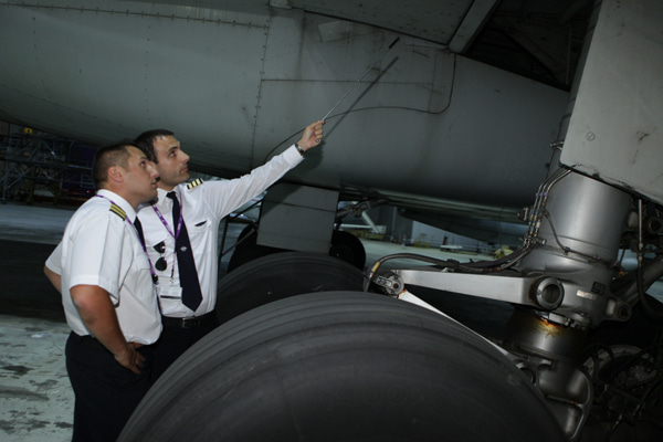 Pilots performing a pre-flight inspection