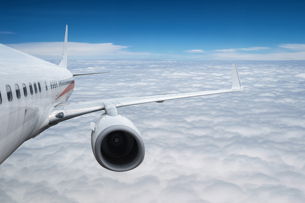 Aircraft flying above a layer of clouds