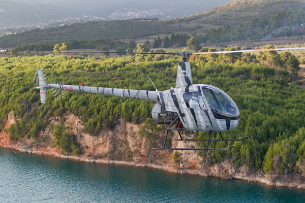 Helicopter robinson r22 over the sea