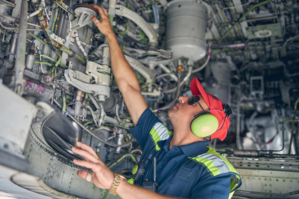 Aviation maintenance technician inspecting the aircraft