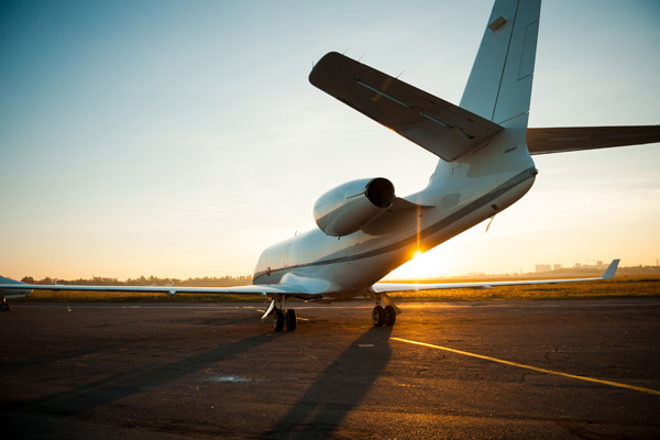 Jet parked on an airport during sunset